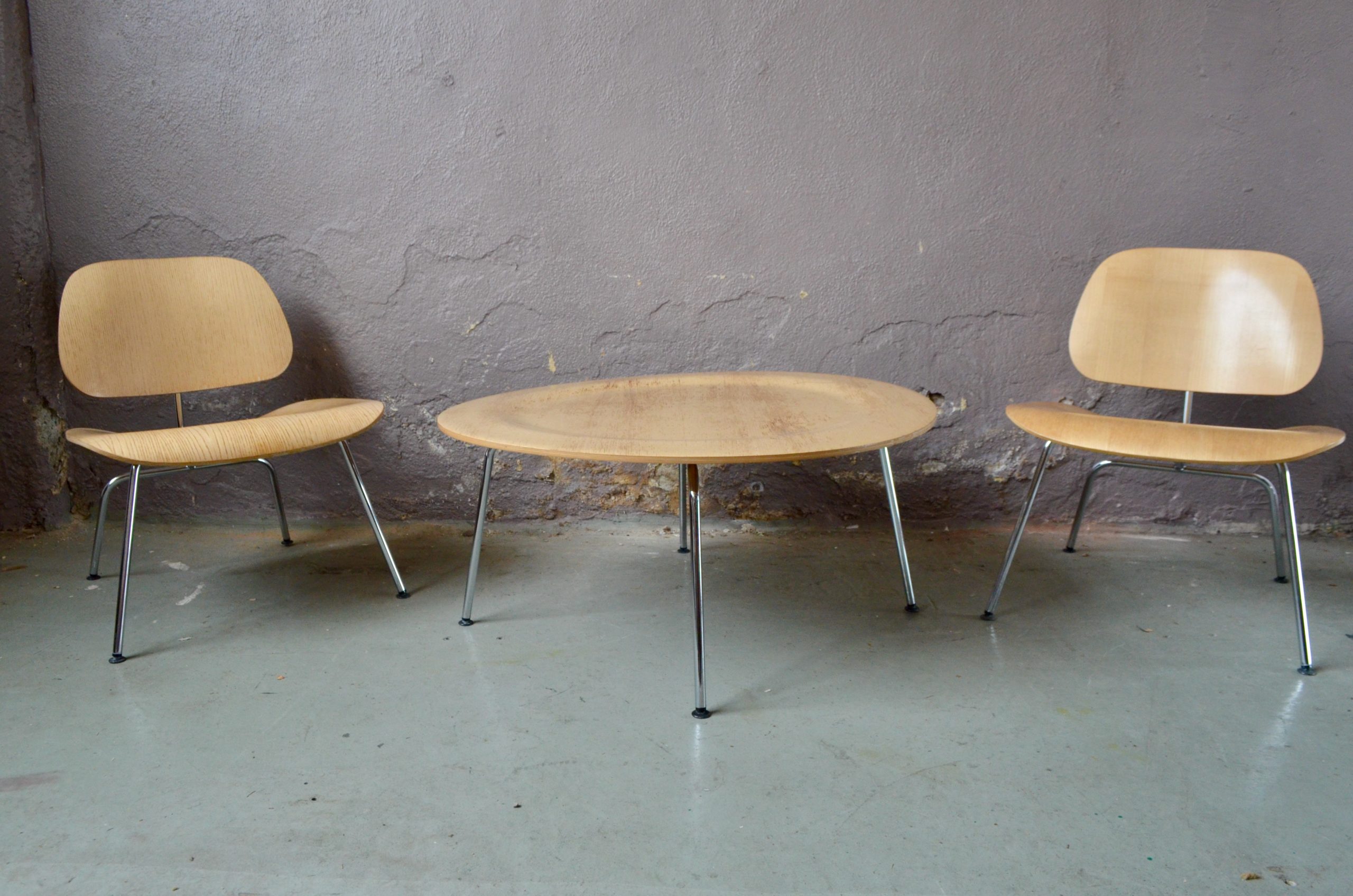 Les fauteuils LCM et la table CTM sont une parfaite illustration du travail des Eames. L'utilisation du tube d'acier et du contreplaqué permettent une production industriel d'un mobilier aux formes arrondies, souples et organiques. Composé de deux chauffeuses et d'une table basse assortie c'est un élégant ensemble de salon, au design exigeant.